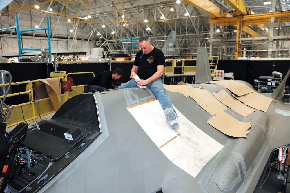 An F-35 strike fighter is worked on by a technician at the Ogden Air Logistics Complex, Hill AFB, Utah.